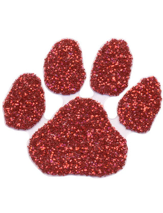 A red glitter-covered paw print temporary tattoo.
