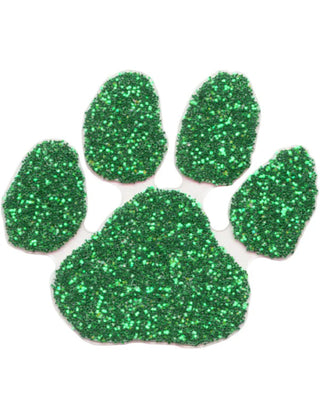 A green glitter-covered paw print temporary tattoo.