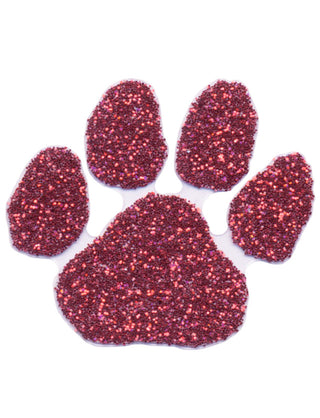 A maroon glitter-covered paw print temporary tattoo.